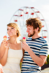 young couple eating ice cream outdoor