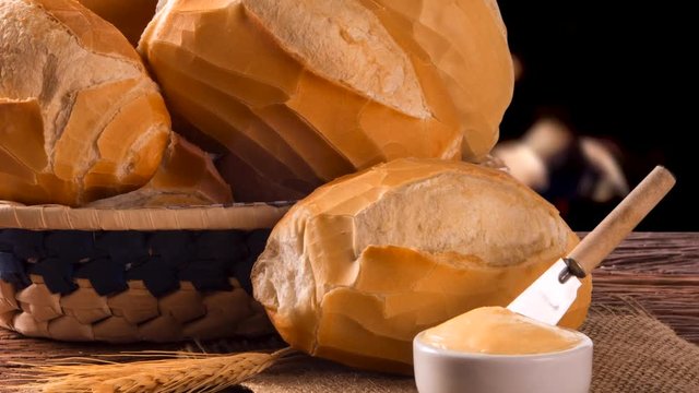 Basket of "French bread", traditional Brazilian bread and butter with fire background
