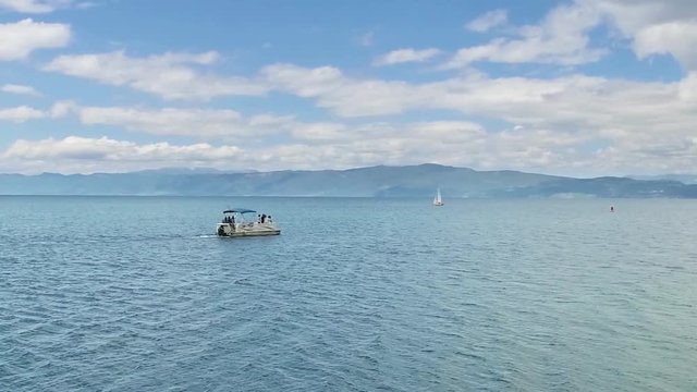 Tourist lboat against day sky on Ohrid lake horizon, Macedonia