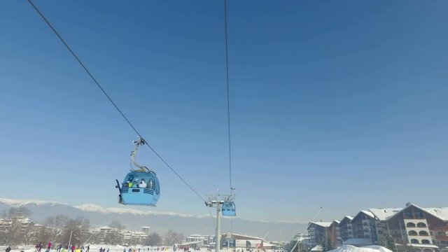 Gondola cabin ski lift transport skiers on mountain ski slopes