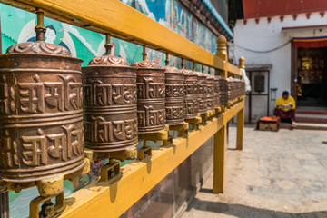 prayer wheels and monk nepal