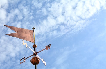 The weathervane in the blue sky with some clouds. - 202071775