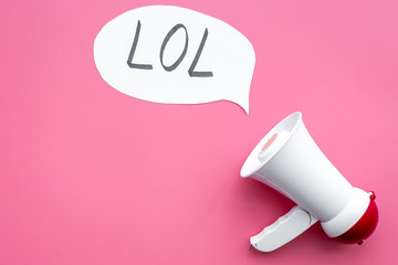 Reaction to something funny. Internet meme LOL. Megaphone near cloud with word LOL on pink background top view copy space