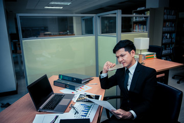 Asian stress business man working fail,The owner of the company blamed him with bad word,Thai employee serious from hard work from boss,Sad handsome guy in black suit