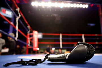 Boxing gloves in boxing ring