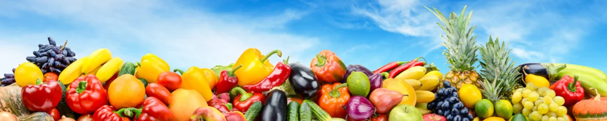 Fotobehang Panorama vegetables and fruits against bright blue sky. © Serghei V