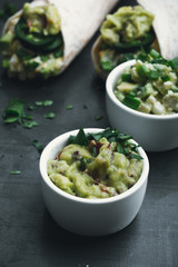 Egg salad and guacamole sauce, flour tortilla wraps