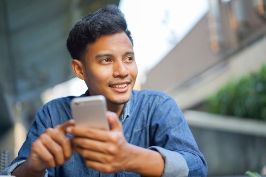 close up hand hold mobile cell phone device:focus on man text on smart phone concept