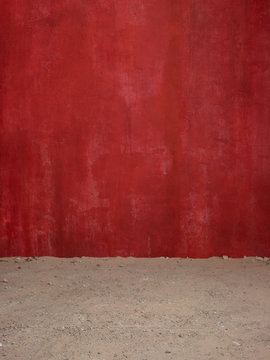Red wall and dirt floor
