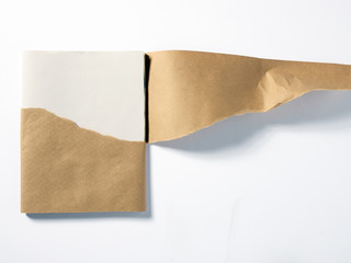 Stack of white paper in peeled brown wrapper