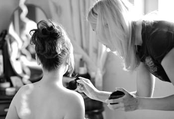 The stylist prepares the bride for the wedding. Morning gathering of the bride.