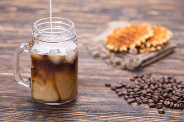Milk is poured into coffee