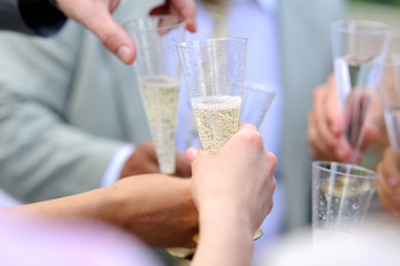 People clink glasses with champagne.