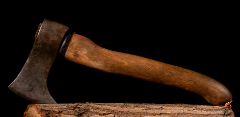 ax on a stump on a black background