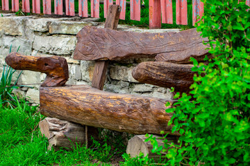Wooden bench made of tree trunks, object