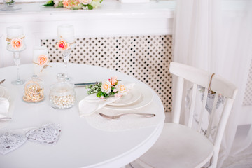 Dining table setting at Provence style, with candles, lavender, vintage crockery and cutlery, closeup.