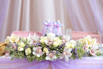 Flower arrangement of roses and orchids, wedding table decoration