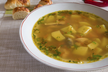 light transparent broth pea soup in a bowl