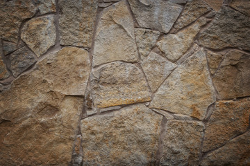 Stones of different size in the wall texture background of natural color