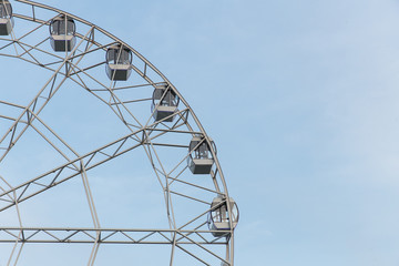 Ferris wheel on a summer day against a clear sky
