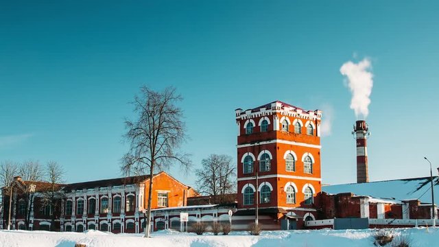 Dobrush, Gomel Region, Belarus. Time Lapse Time-lapse Timelapse From Day To Night Of Old Paper Factory Tower In Winter. Historical Heritage And Local Landmark