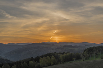 Fototapeta na wymiar Sunrise with Krkonose mountains near Roprachtice village