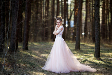 Portrait of beauty bride in white dress. bride is walking in the woods.