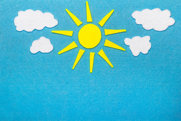 Colorful felt background with sun and clouds, copy space