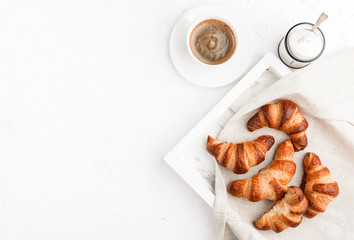 croissants with a cup of coffee on a white background