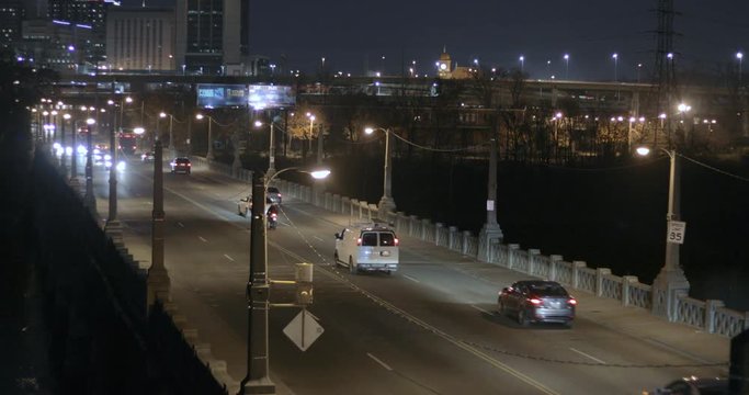 Car, Truck And Motorcycle Traffic On Old 14th Street Bridge In Richmond Virginia At Night With Streeetlights And The City In The Background