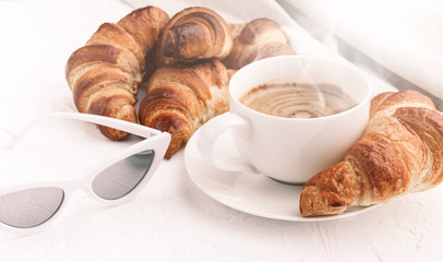 croissants with a cup of coffee on a white background