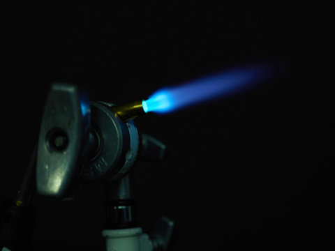 Blow torch in vise grip close-up