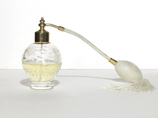 Perfume bottle with atomizer on white background