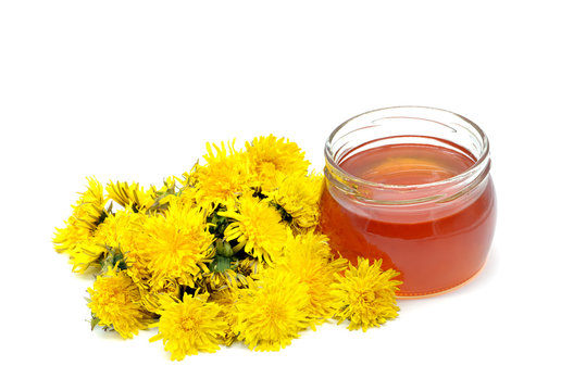 Fototapeta homemade Dandelion honey with honey glass and flower heads of danelion flower. isolated white background
