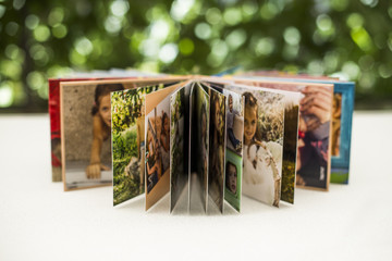 Family photos archive saved in brightly designed photo book; bright summer memories placed in the...