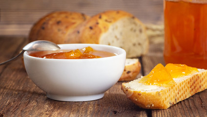 Breakfast with apricot jam and slice of bread