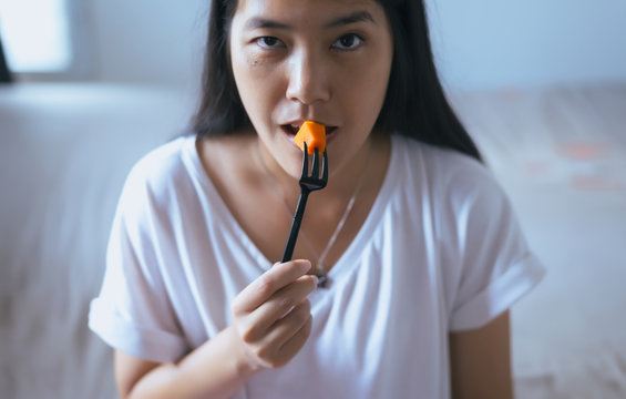 Young asian woman having fresh fruits papaya slices,Concept healthy food