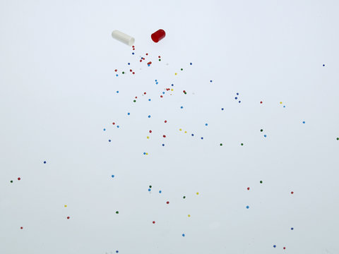 Spilled medicine from open pill capsule