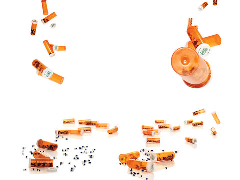 Prescription pill bottles falling mid air