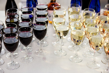 out catering, glasses with white and red wine, champagne, whiskey, juice and mineral water are on  table for the guests of  event