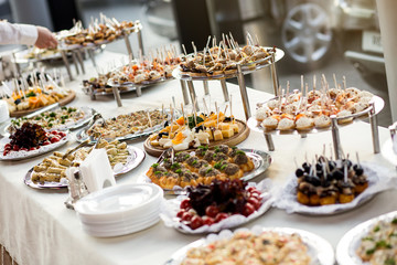holiday buffet table served by different canape, sandwiches, snacks ready for eating in restaurant