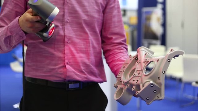Engineer scans the part with 3D scanner
