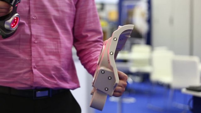 Engineer scans the part with 3D scanner