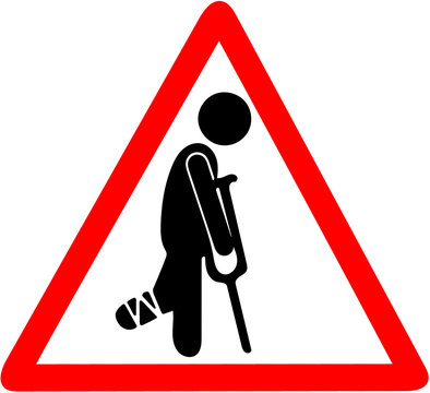 temporarily injured man in bandage with crutches warning red triangle road sign isolated on white