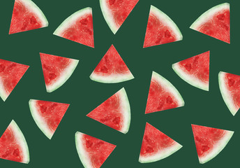 Colorful fruit pattern of fresh watermelon slices on green background. From top view