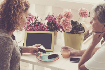 couple of women eating cake and drinking fruit juice outdoor