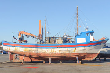 old wooden sailing vessel on supports