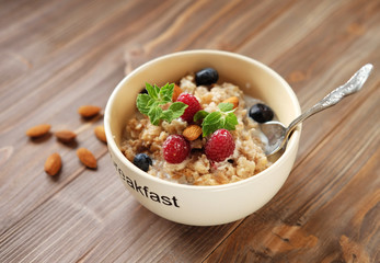 Oatmeal with fresh berries and nuts close up