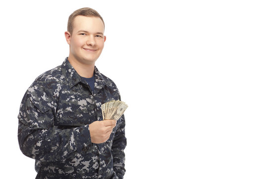 Young man in navy uniform with money