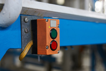 Start or stop button for industrial machine, close-up. Emergency Stop for Safety concept. Red...
